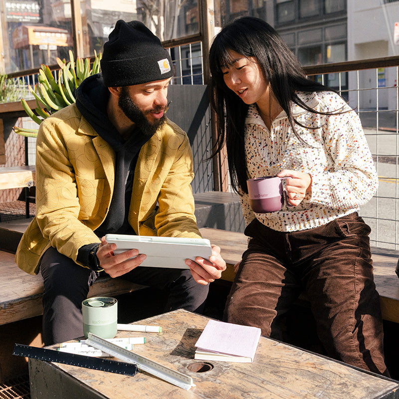 12oz-rise-mug-k9 12oz_rise_coffee_mug_dusty_orchid_couple_city_patio_square.jpg