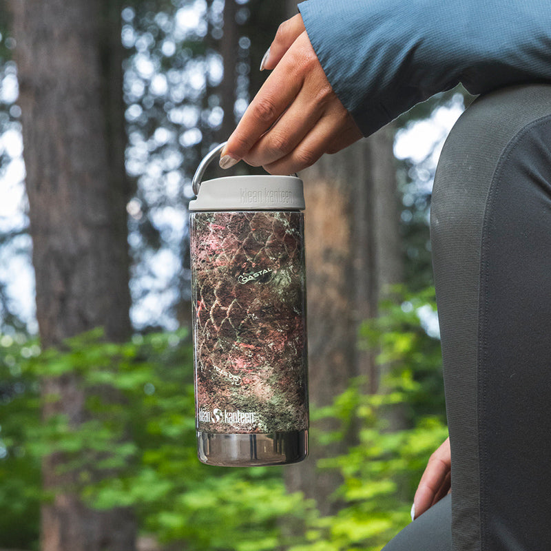 12oz-tkwide-with-twist-cap-mossy-oak-t6 12oz_tumbler_mossyoak_rainbowtrout_hand_closeup_square.jpg