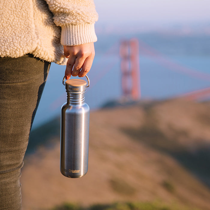 27oz-reflect-with-bamboo-cap-q1 K27SSLRF-BS-BAMBOO_reflect_bottle_bridge_lifestyle.jpg